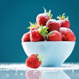 Fresh strawberries on a light surface (for seasonal strawberry-vanilla jam)